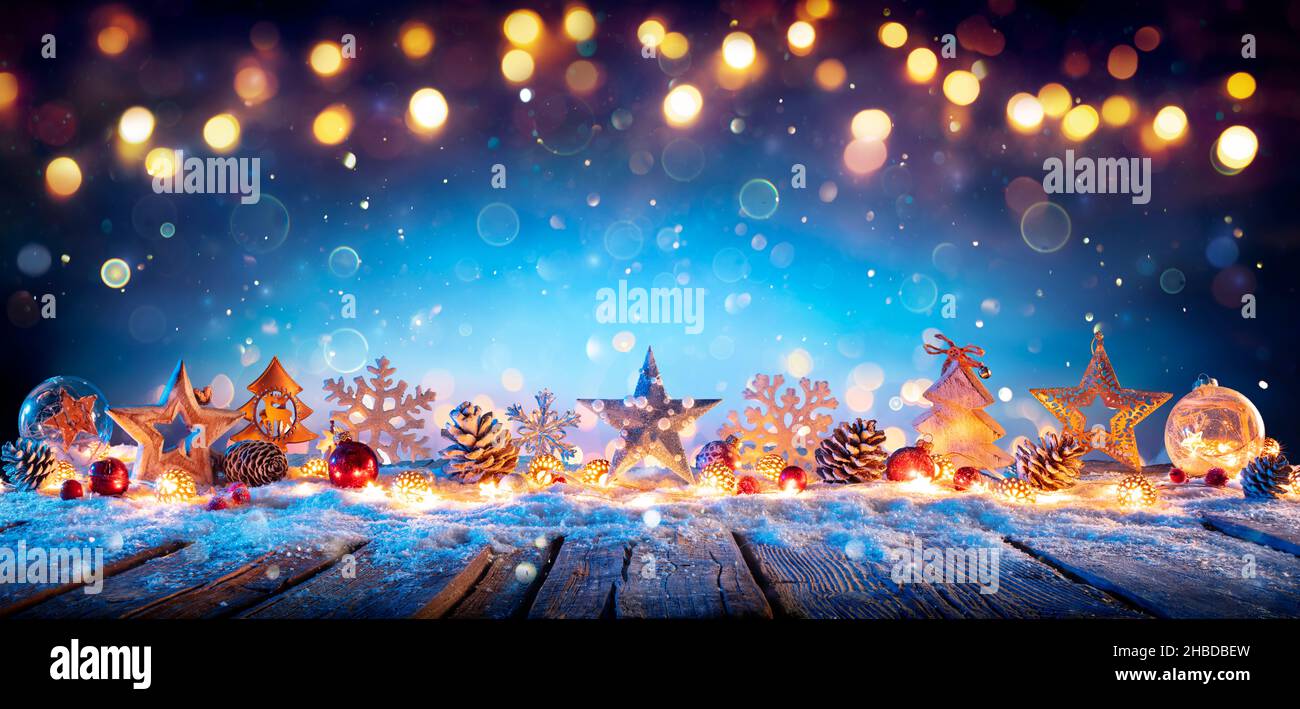 Christmas Decoration On Wooden Table In Blue Abstract Defocused Backdrop Stock Photo