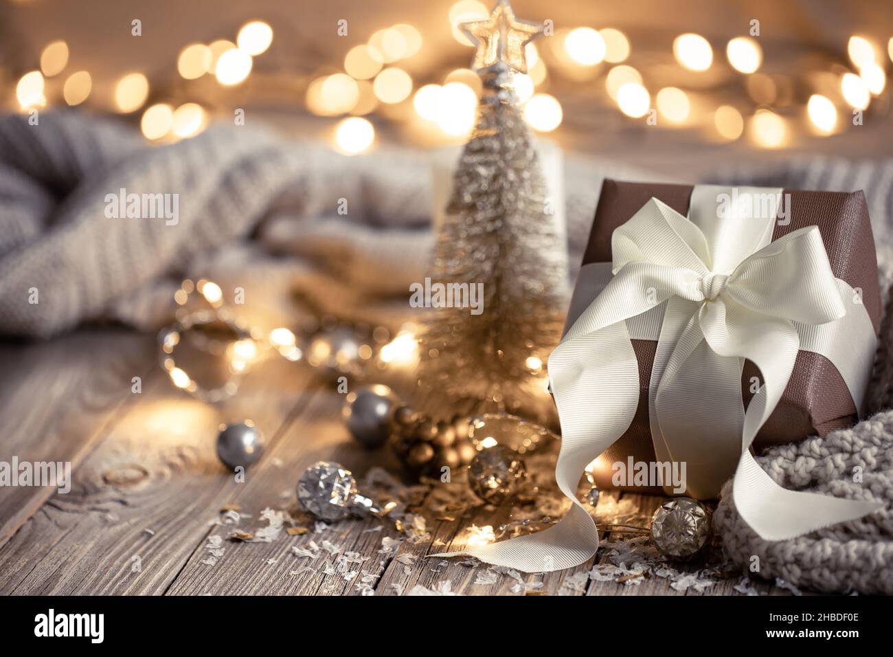 Christmas composition with a festive gift on a blurred background. Stock Photo