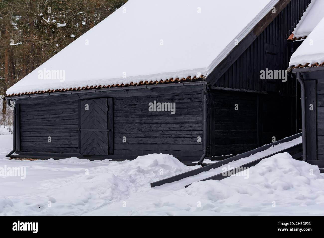 Dark blue Kurzeme harbour warehouse under snow Stock Photo