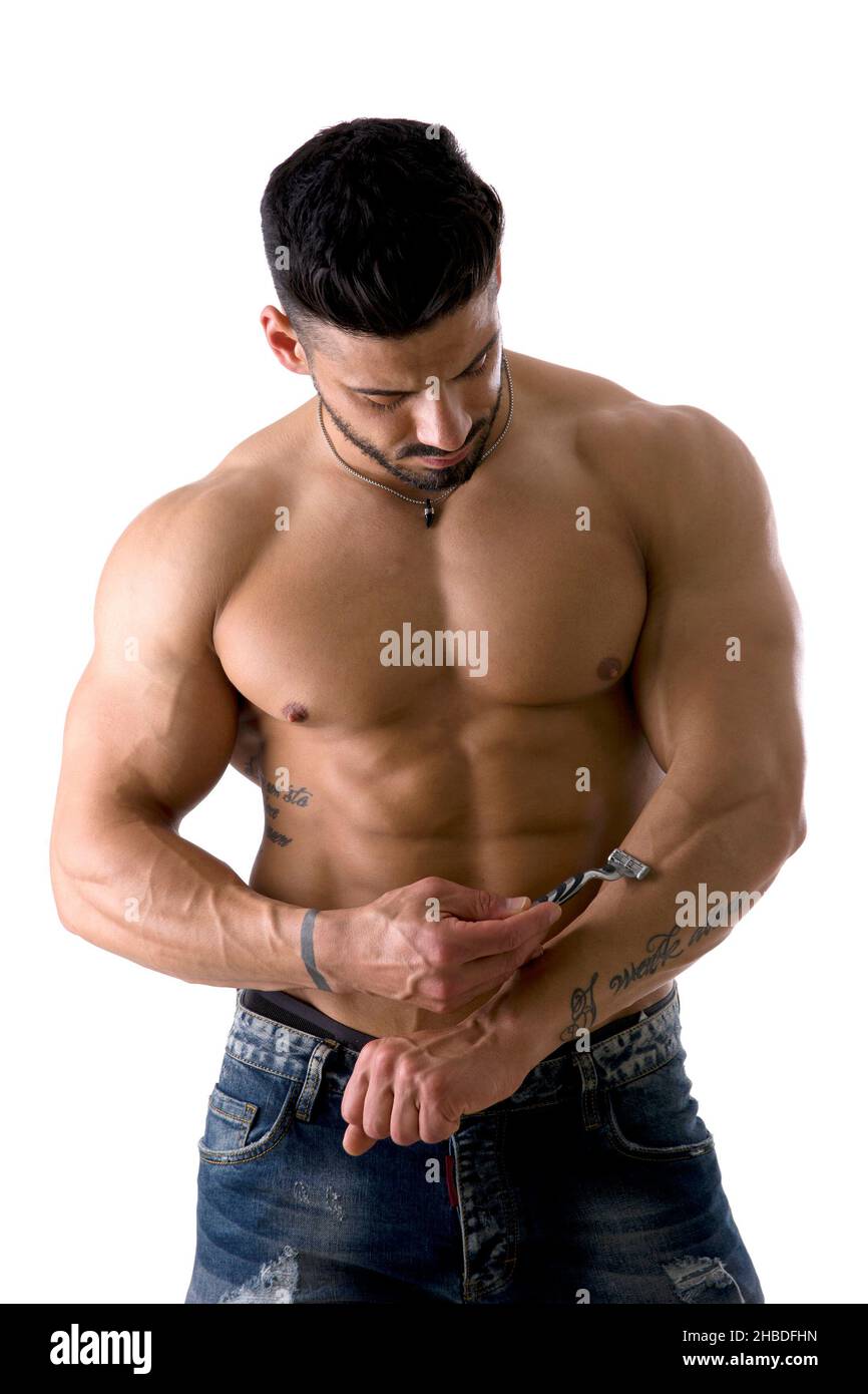 Handsome Muscled Man Shaving his Chest in Studio Shot Stock Photo
