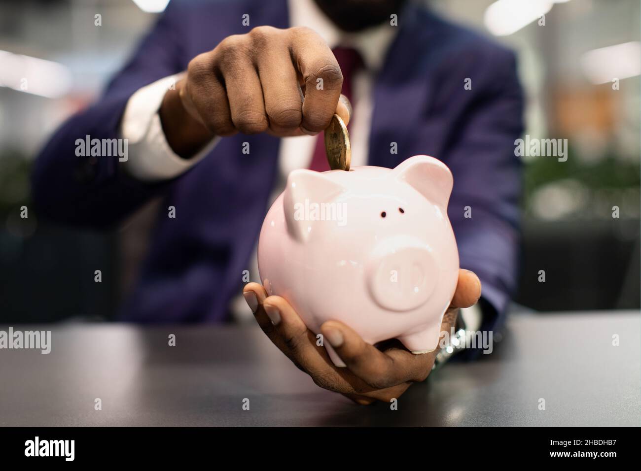 Unrecognizable african american man in suit making savings Stock Photo