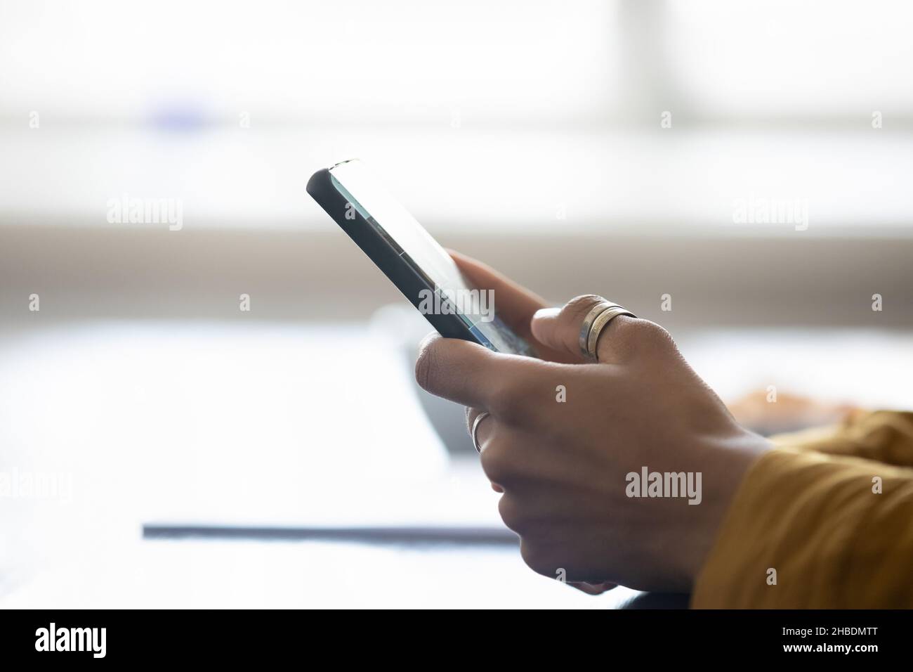 Close up side view young woman using smartphone. Stock Photo
