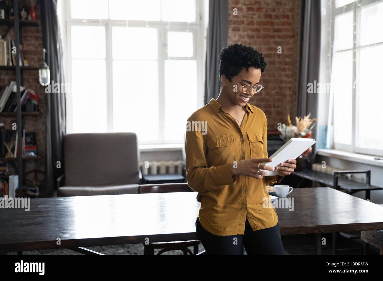 Happy young African American woman using digital tablet Stock Photo - Alamy