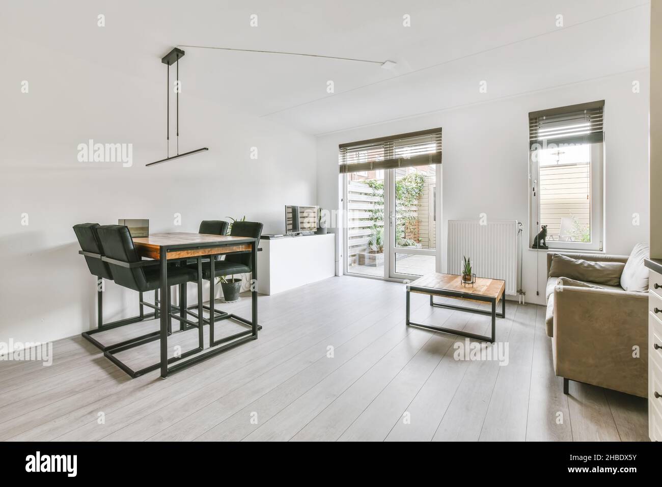 Combined living room with dining area in a minimalist style Stock Photo