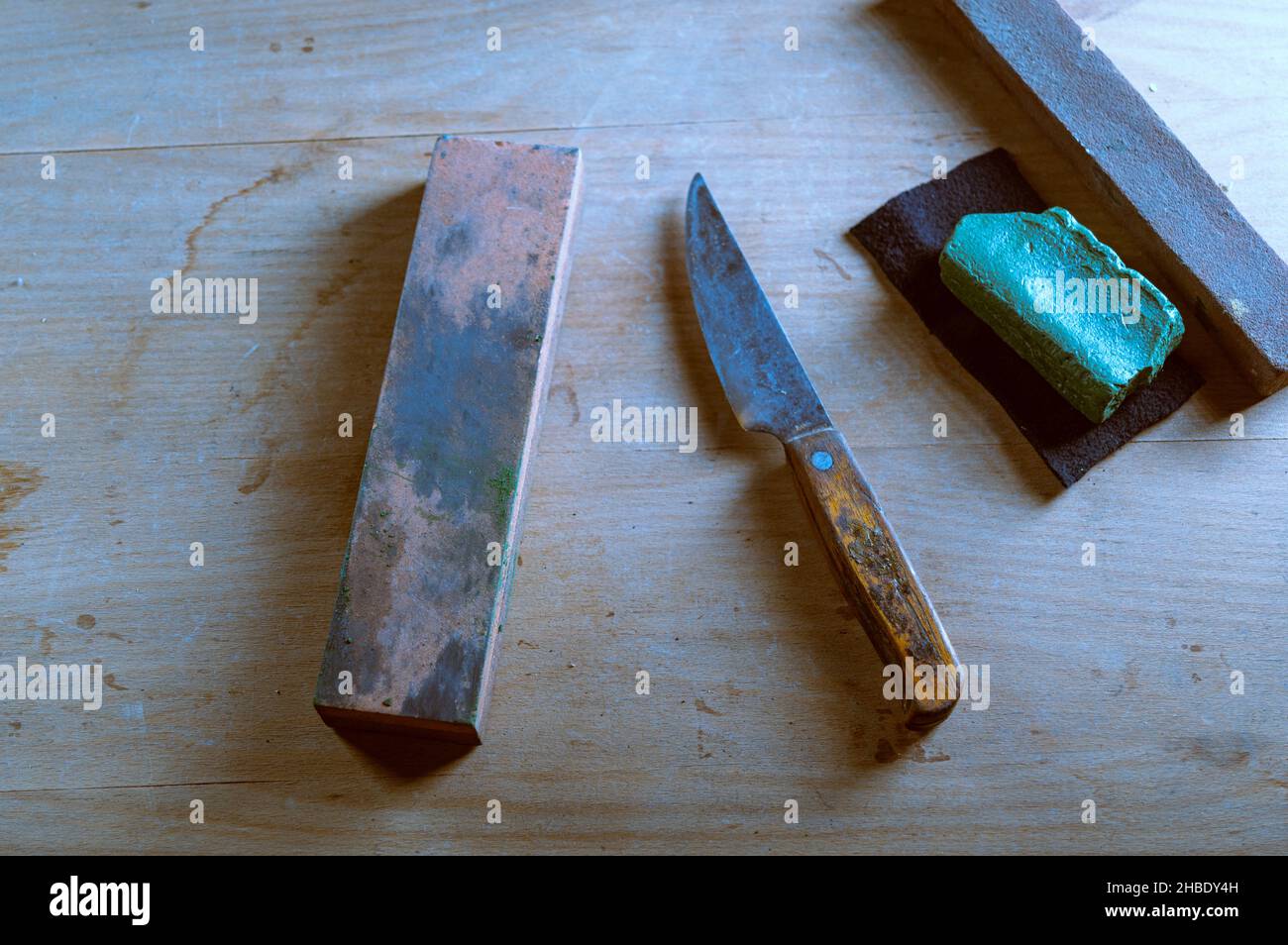 Old kitchen knives and whetstone. Sharpening stones and an old knife