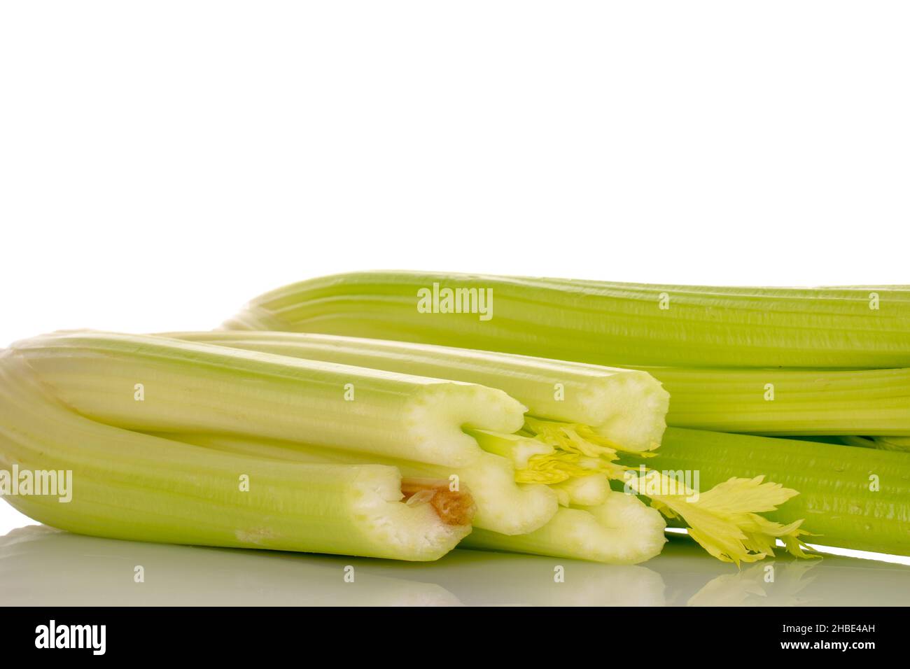 Two light green natural, juicy stalks of celery, close-up, isolated on white. Stock Photo