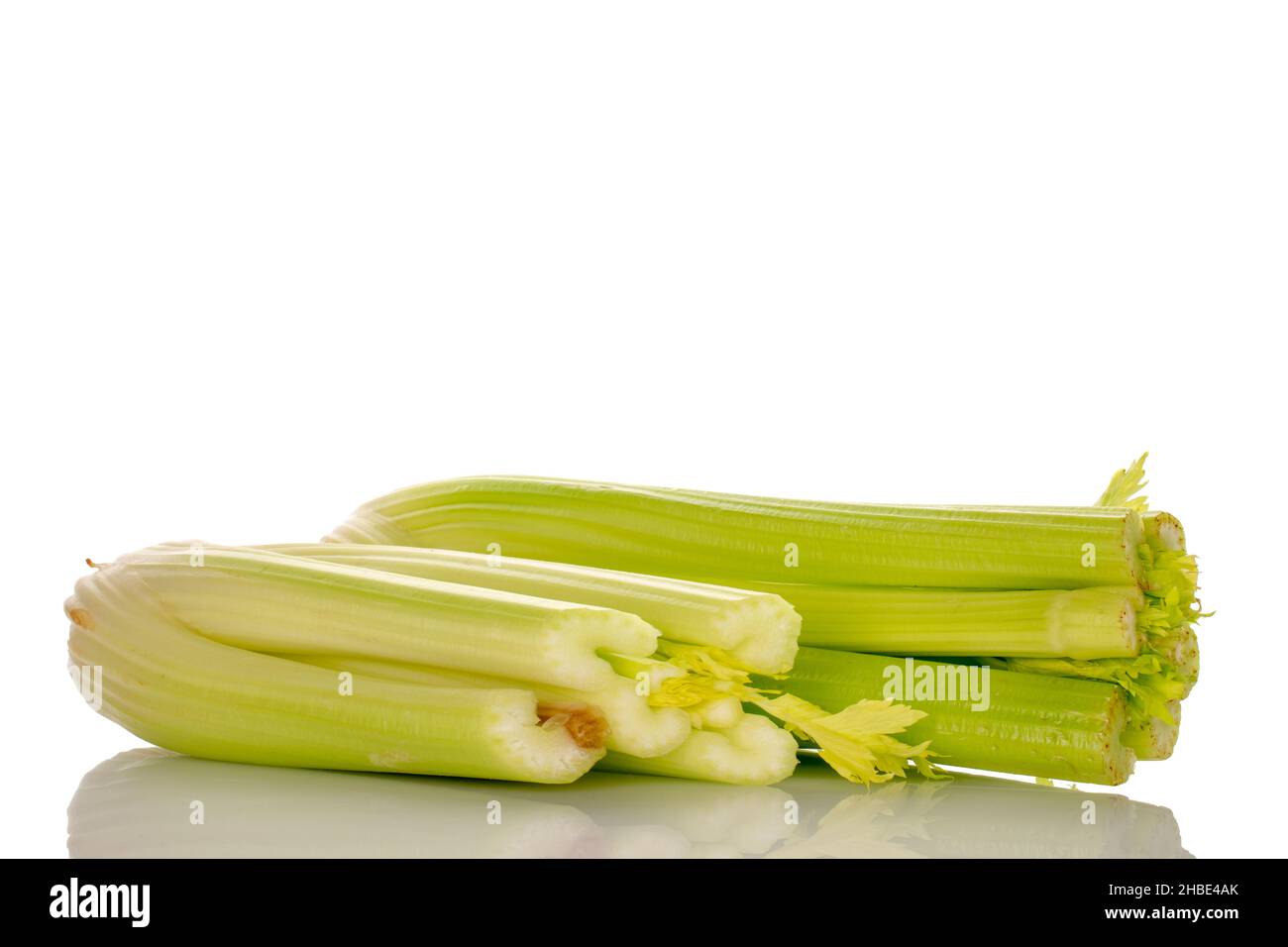 Two light green natural, juicy stalks of celery, close-up, isolated on white. Stock Photo
