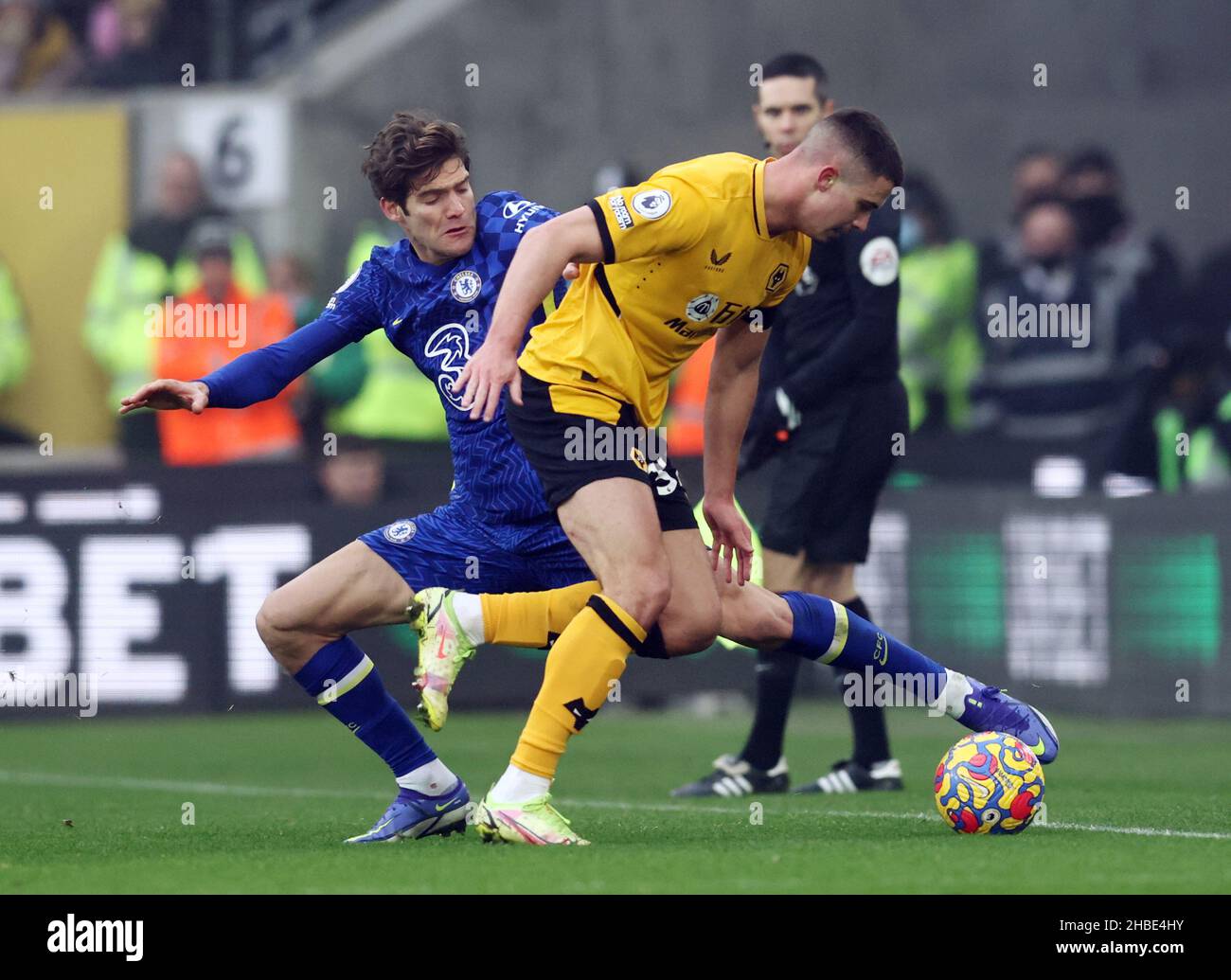 Wolverhampton, England, 19th December 2021. Marcos Alonso of Chelsea tackles Leander Dendoncker of Wolverhampton Wanderers  during the Premier League match at Molineux, Wolverhampton. Picture credit should read: Darren Staples / Sportimage Stock Photo