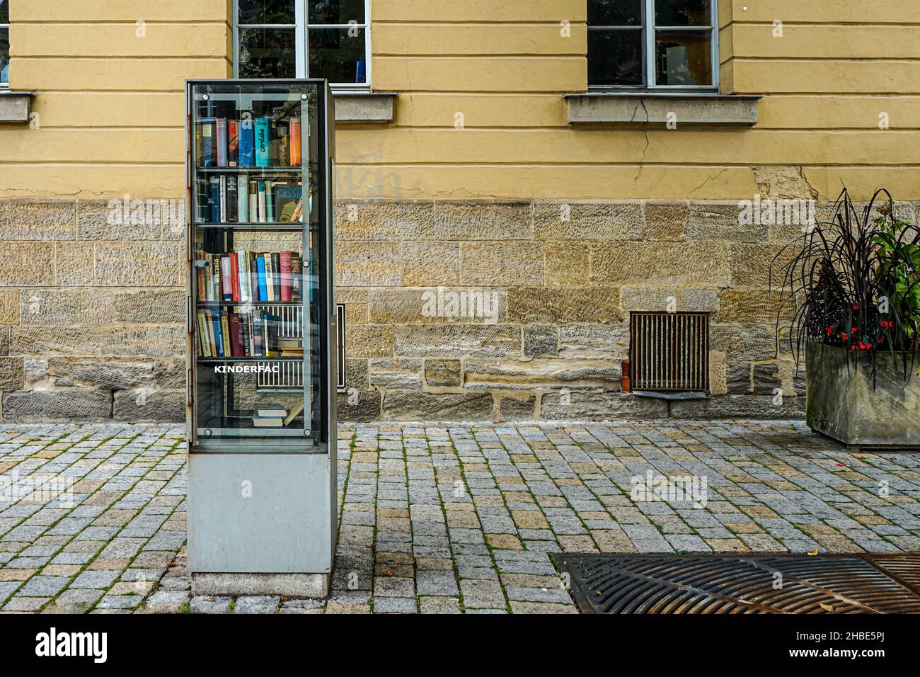 A small public library cupboard on a pavement. Stock Photo