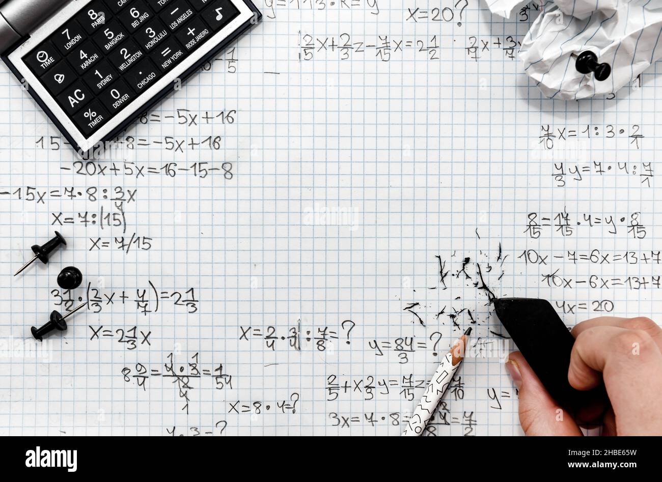 The hand erases mathematical equations with an eraser. Eraser and