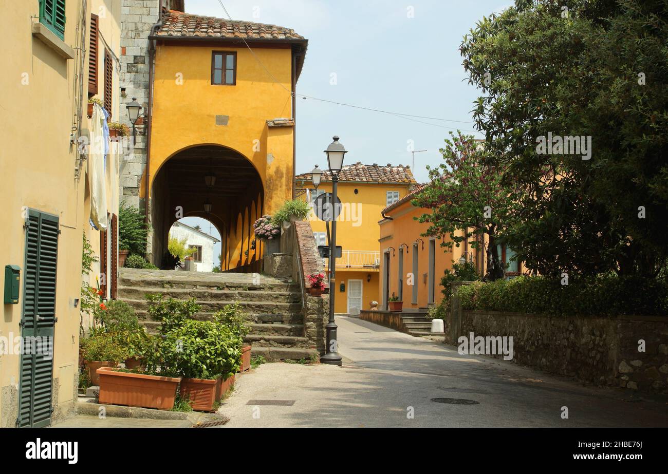 Small street and shady gallery in Serravalle Pistoiese  a very small and old town in Tuscany. Stock Photo