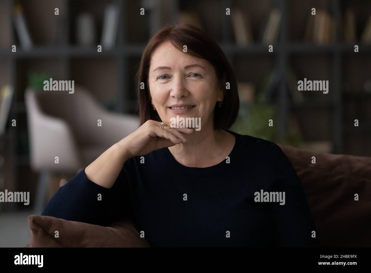 Beautiful intelligent well groomed aged female posing for headshot portrait Stock Photo