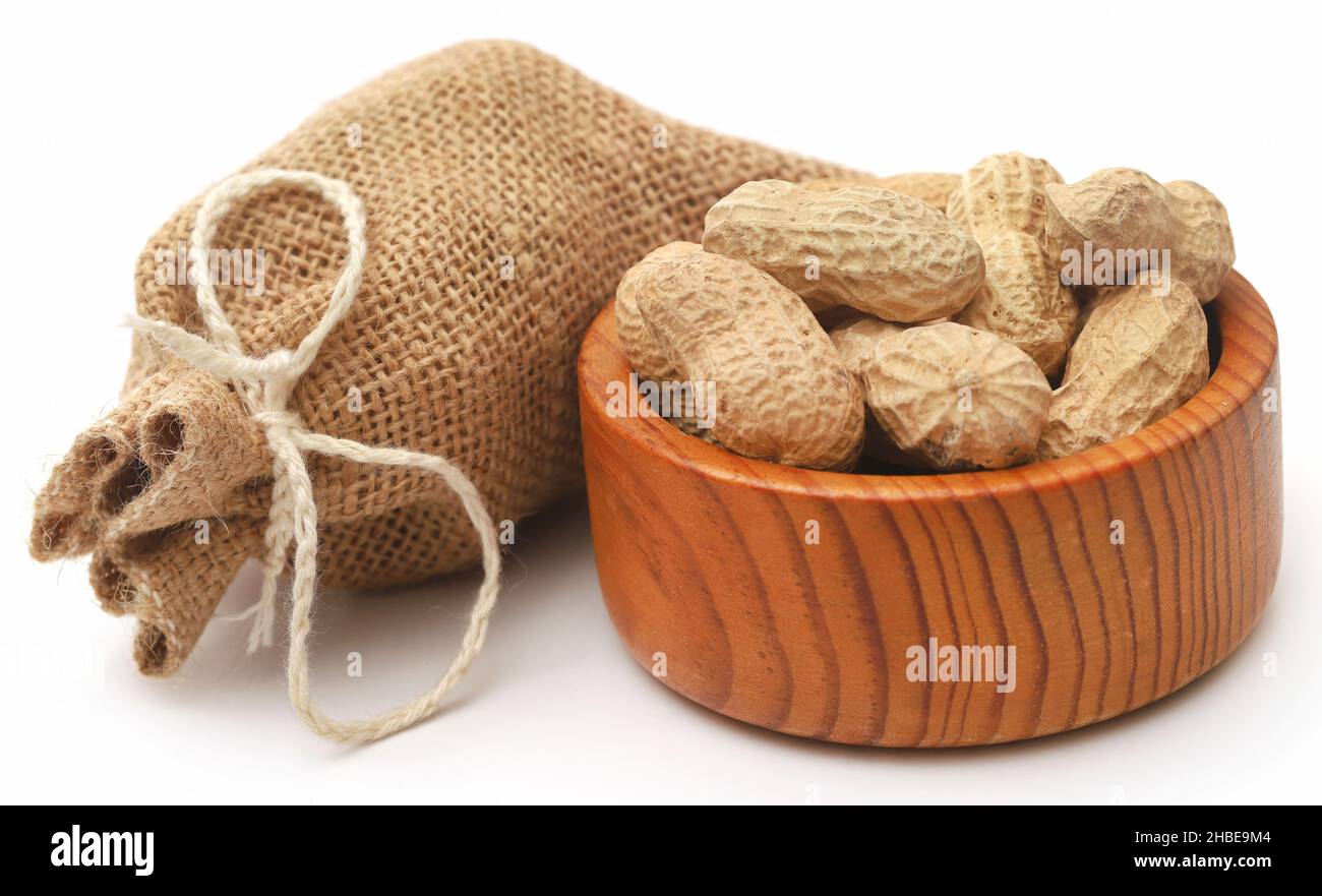 Fresh Peanuts in sack over white background Stock Photo