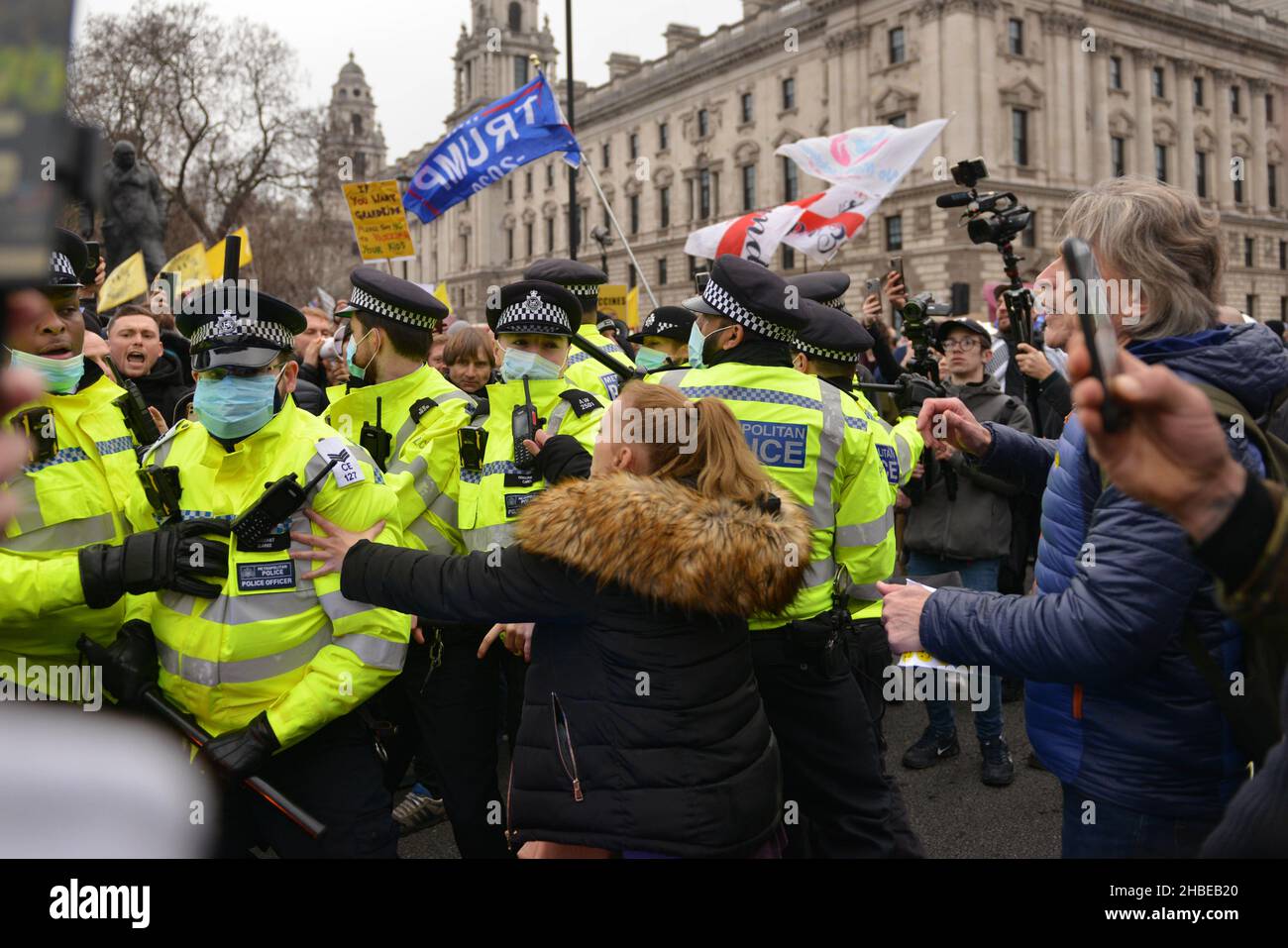 Police scuffling with protesters trying to prevent a blockade of the street, during the demonstration. Anti vaccine and anti vaccine pass protesters joined by opponents of Covid 19 restrictions, gathered at Parliament Square and marched through central London. Stock Photo