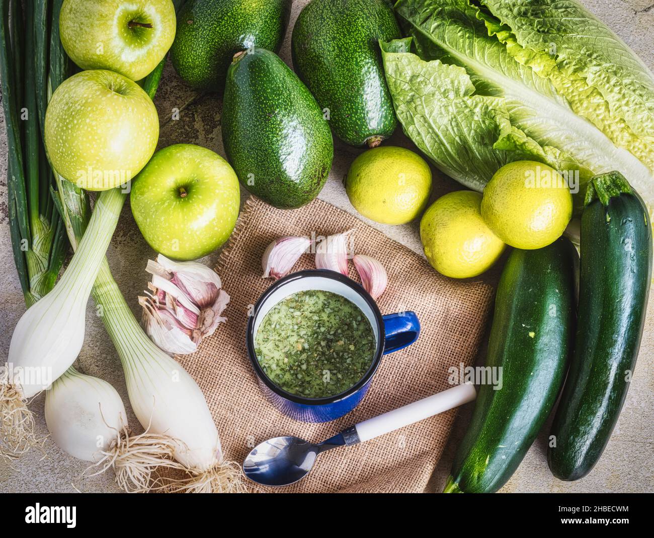 Vegan green breakfast food in a Cup with spinach, onion, avocado, seeds