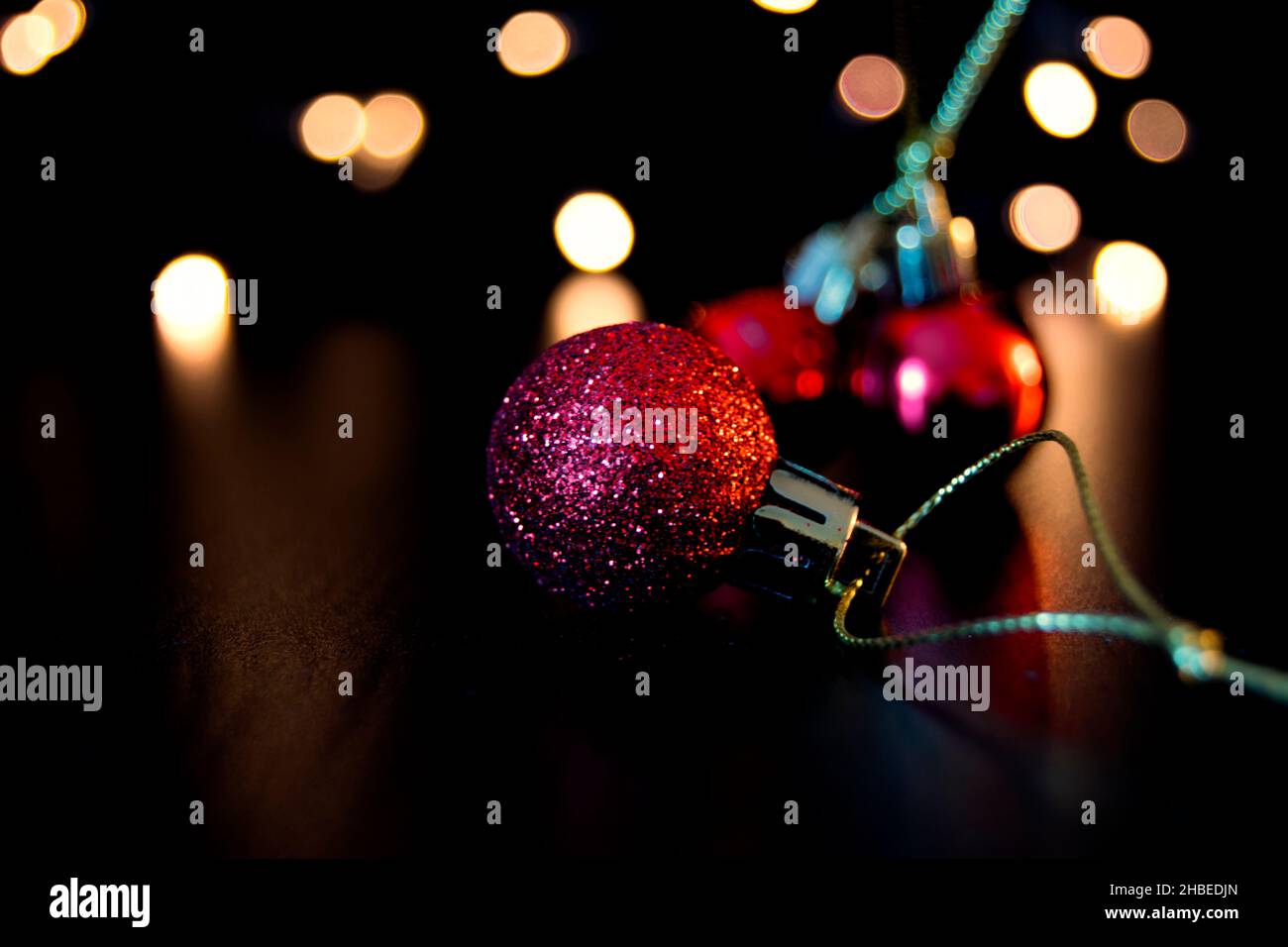 Coloured Christmas baubles and fairy lights Stock Photo