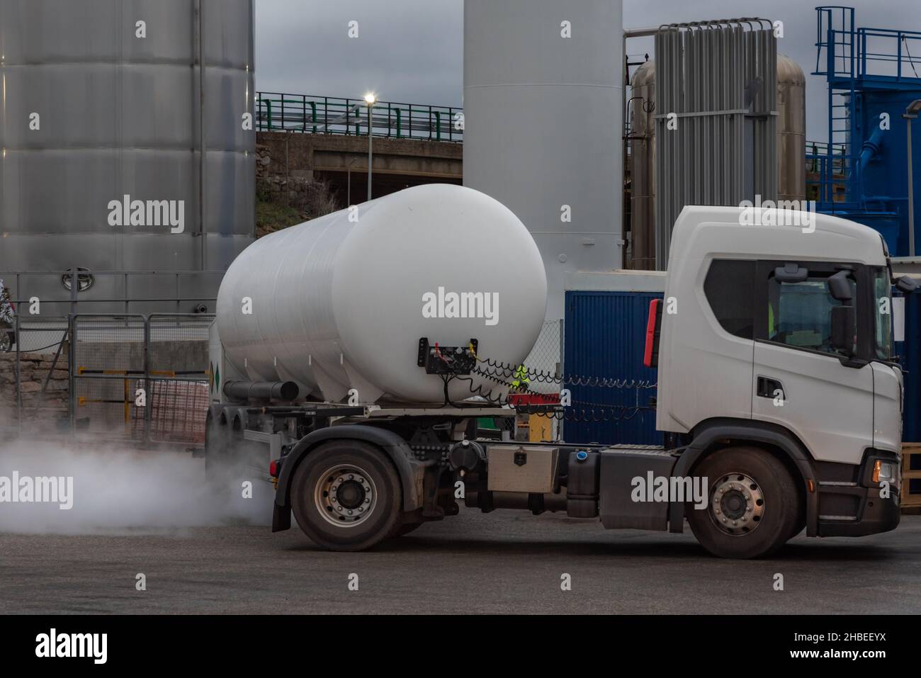 Tank truck for the transport of cryogenic gases unloading in a tank. Stock Photo