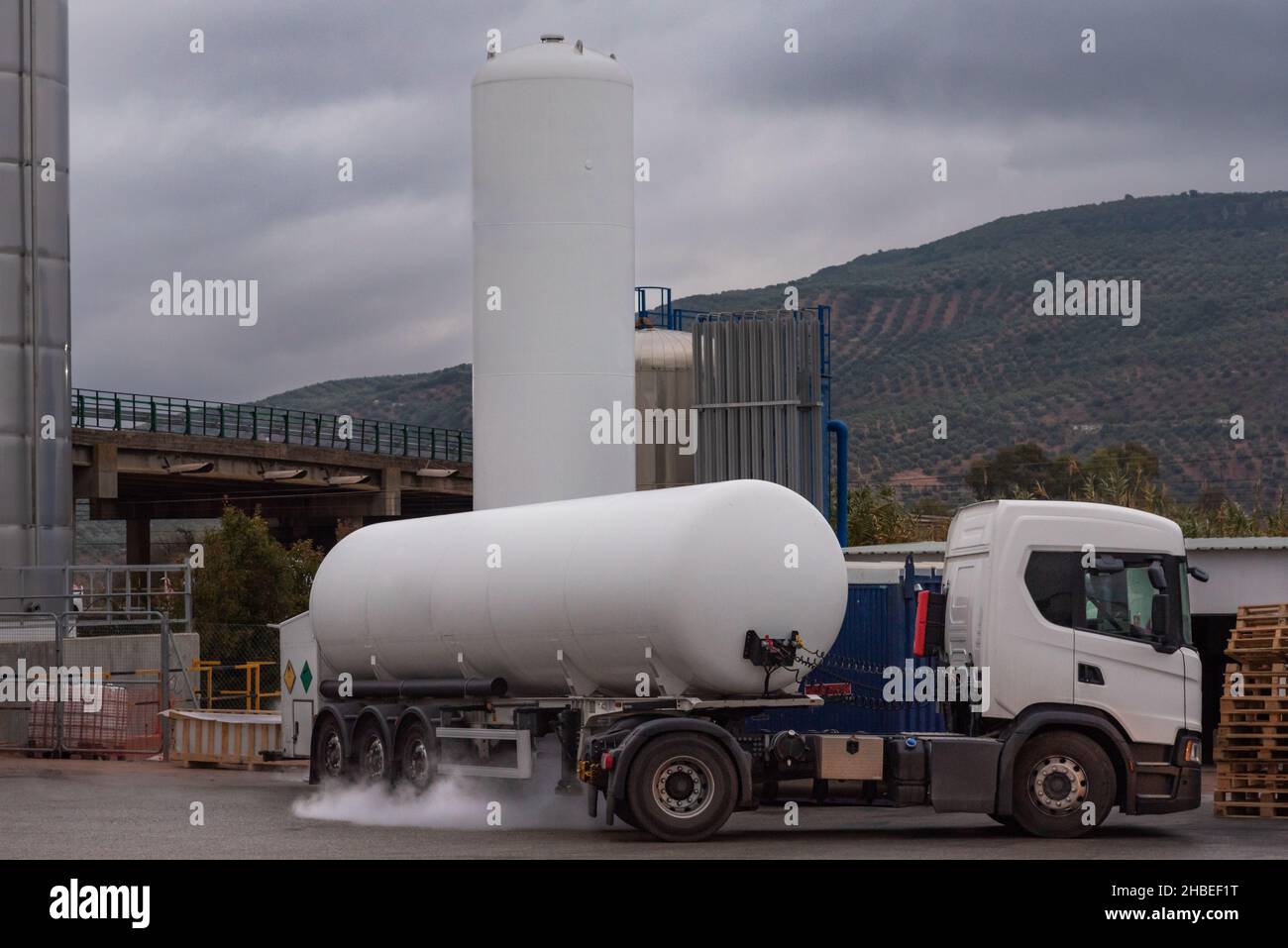 Tank truck for the transport of cryogenic gases unloading in a tank. Stock Photo