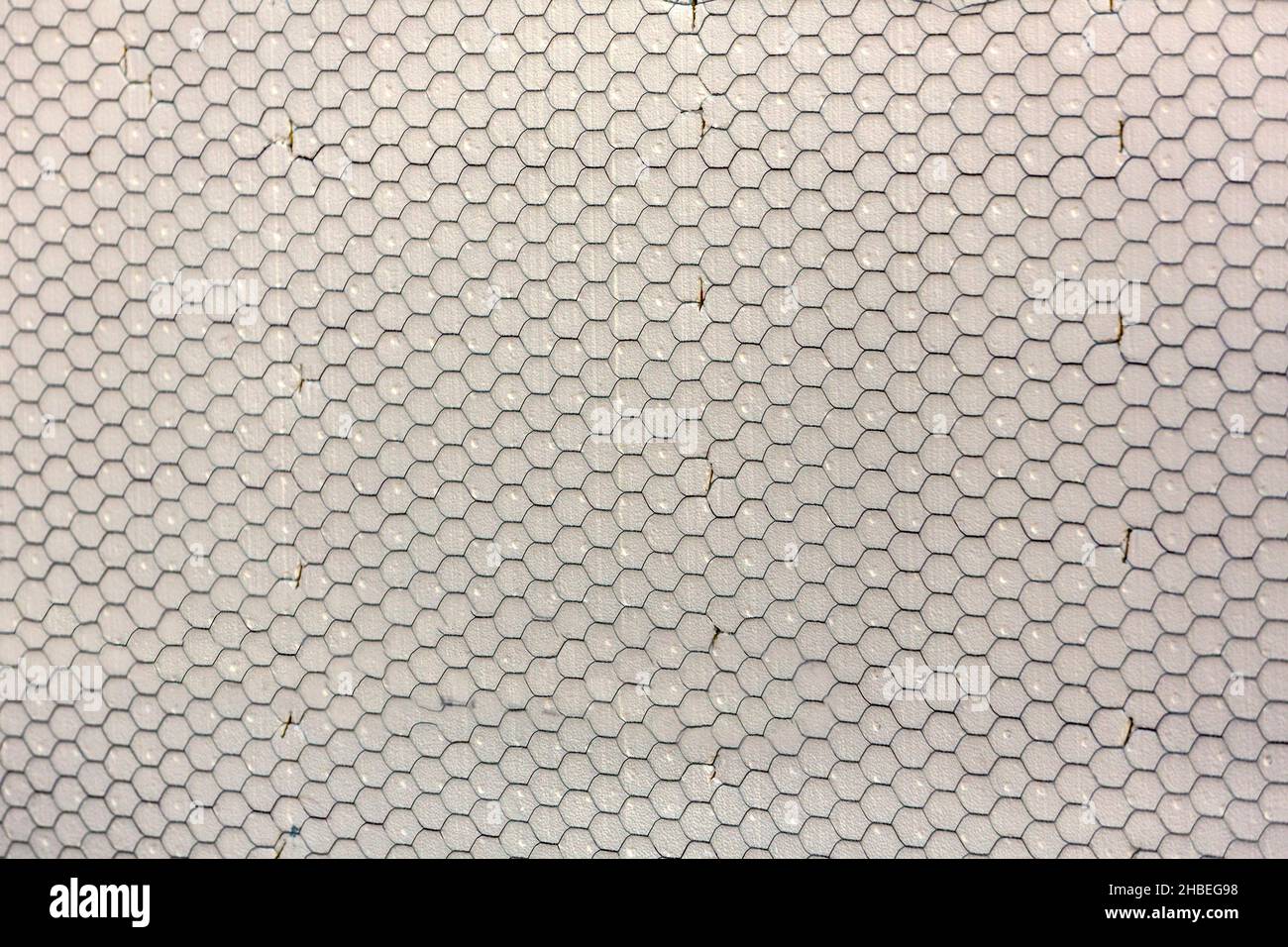 Construction mesh stretched over foam on a wall Stock Photo