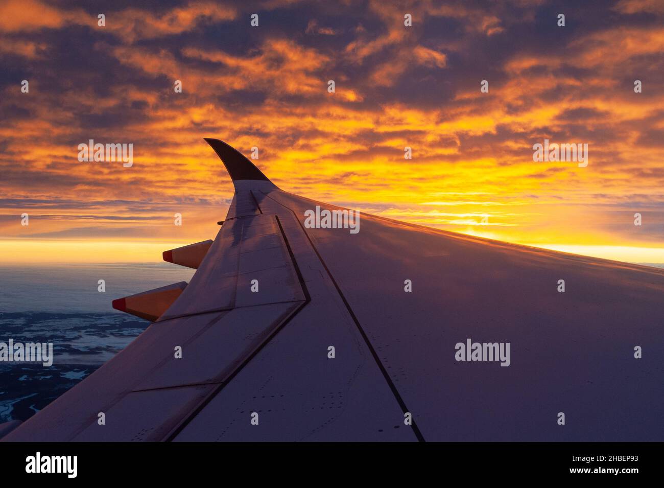 14.12.2021, Zurich, Switzerland, Europe - Flight with Singapore Airlines to Zurich at a beautiful sunrise and aerial view from plane of wing and sky. Stock Photo