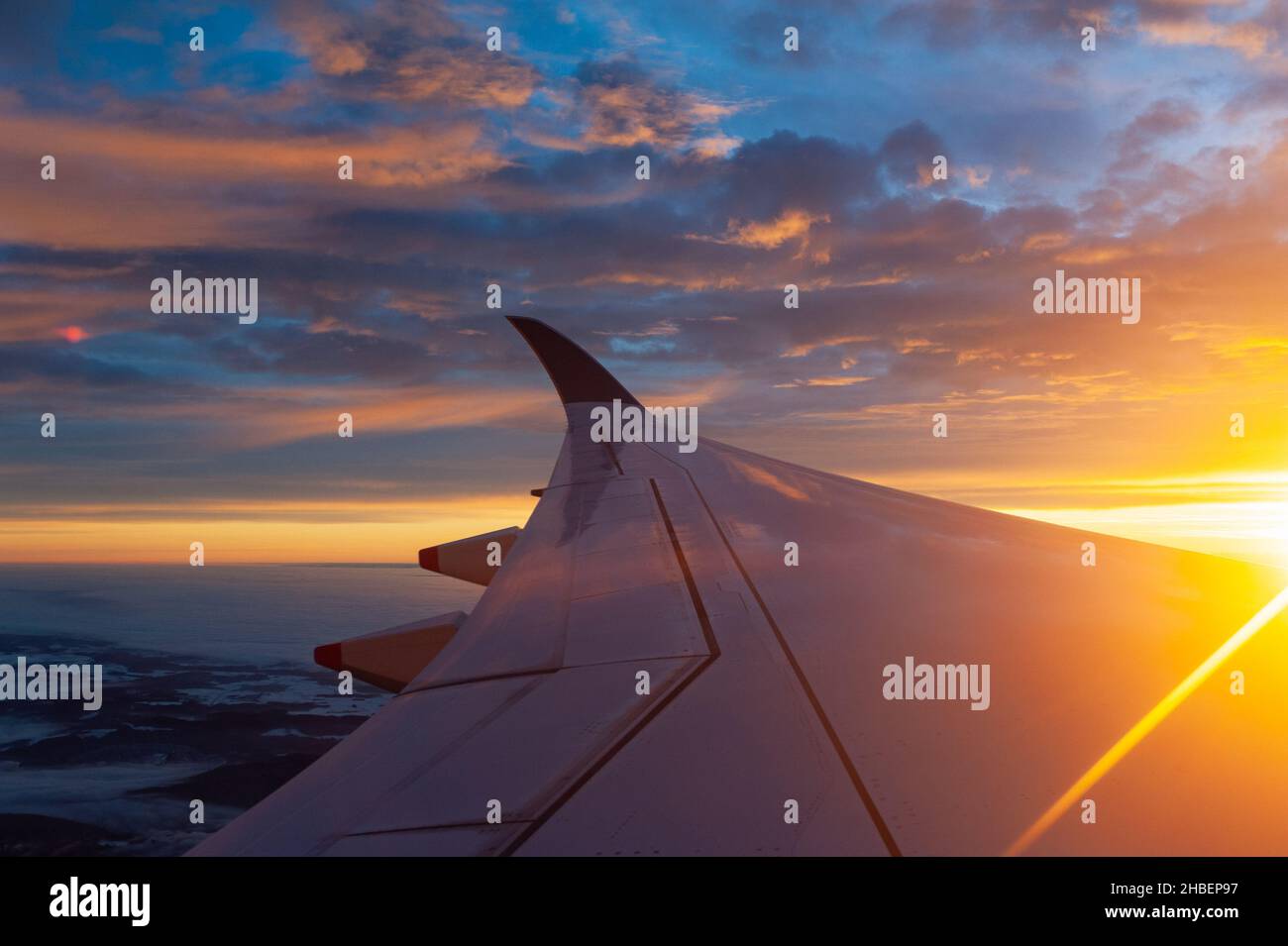 14.12.2021, Zurich, Switzerland, Europe - Flight with Singapore Airlines to Zurich at a beautiful sunrise and aerial view from plane of wing and sky. Stock Photo