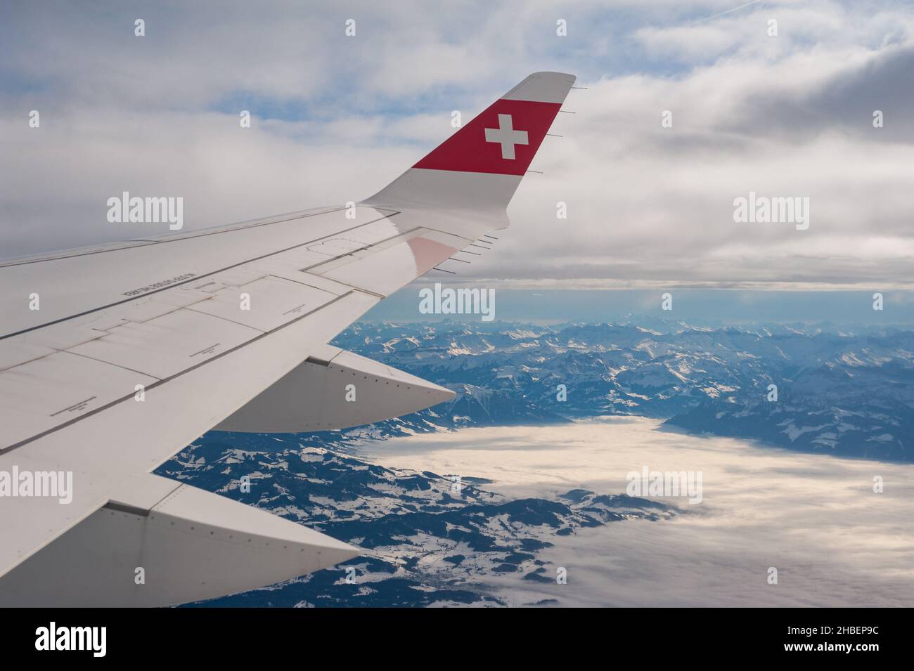 14.12.2021, Zurich, Switzerland, Europe - Flying with Swiss from Zurich to Berlin with aerial view from the airplane of wing and the snowy landscape. Stock Photo