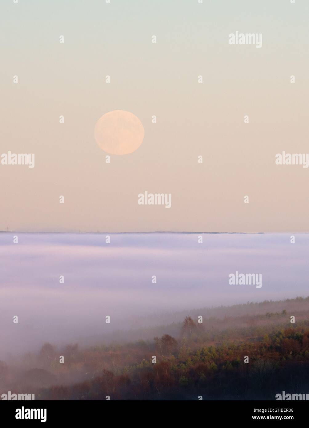 moon above cloud inversion - Campsie Fells, Scotland, UK Stock Photo