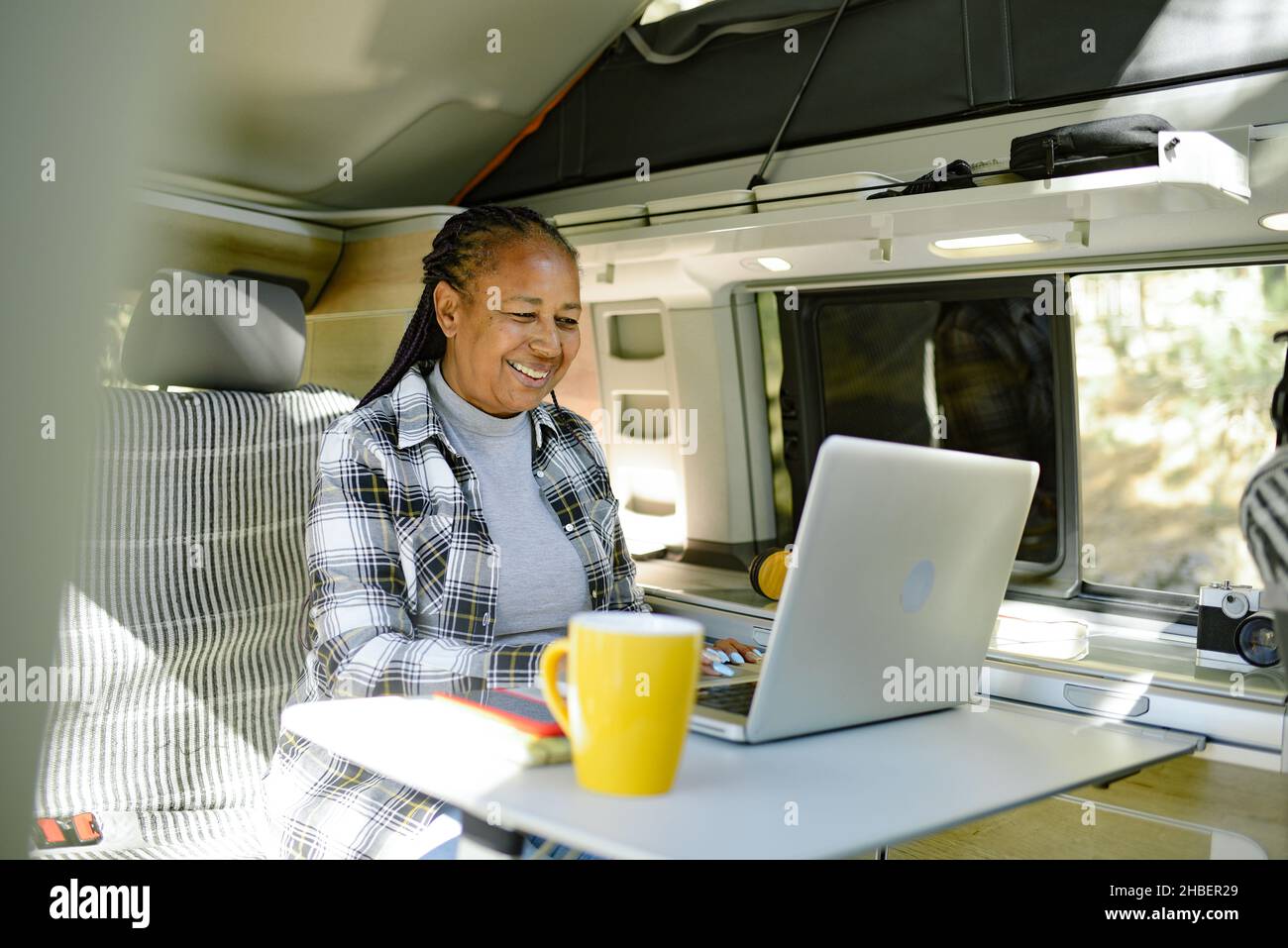 Black traveler browsing laptop during trip Stock Photo