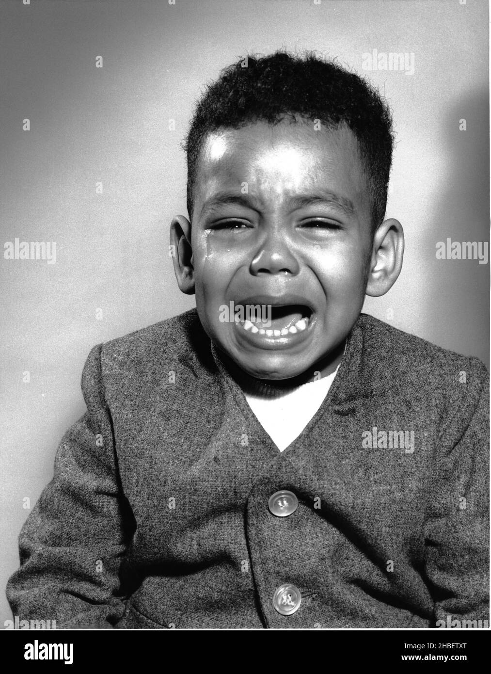 African American boy nicely dressed crying Stock Photo