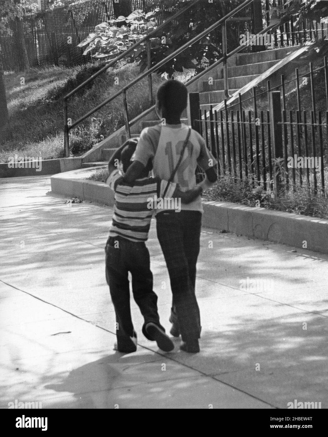 Two boys arms around each other Black and White Stock Photos & Images ...