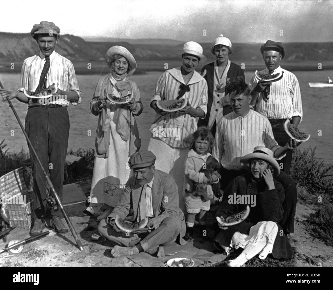 Fish 1925 Group of family and friends take a break from fishing to chow down on ...