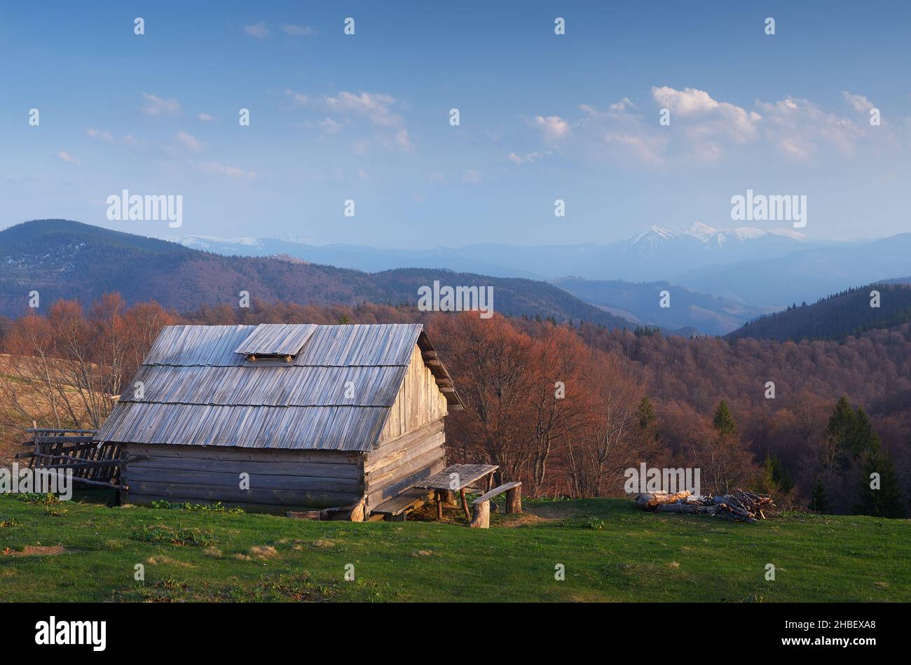 Evening landscape with a wooden house in the mountains. Spring evening. Carpathians, Ukraine Stock Photo