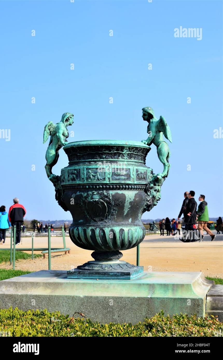 Bronze statue of three cherubs on the edge of a basin of the Bassin du Midi in the gardens of Versailles, in front of the west facade of the Palace of Stock Photo