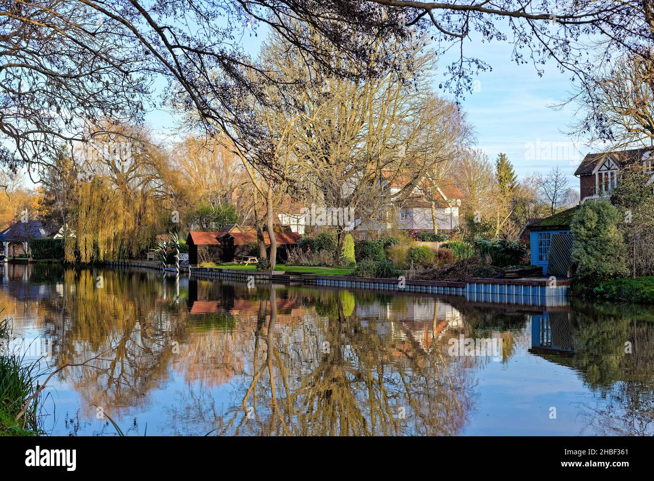 A quiet backwater of the River Wey navigation canal at Weybridge on a sunny winters day Surrey England UK Stock Photo