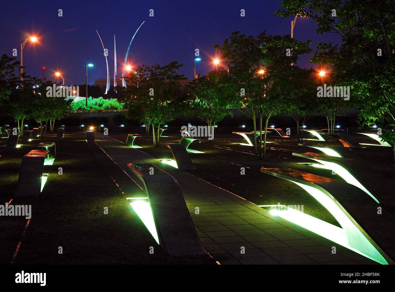 The Pentagon 9/11 Memorial glows with the Air Force Memorial rising behind it Stock Photo