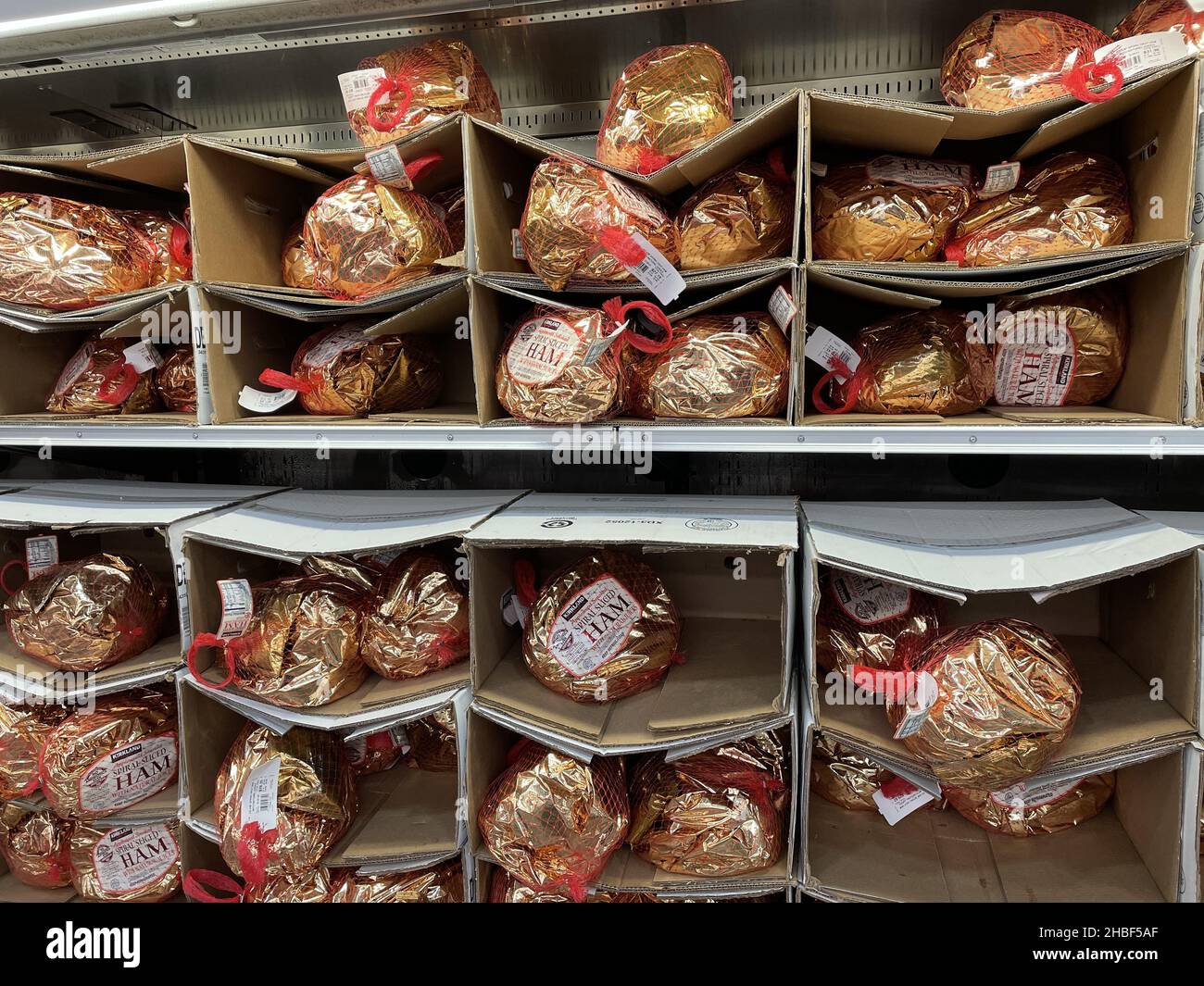 FRESNO, UNITED STATES - Nov 16, 2021: A closeup of Costco Ham in gold colored wrapping on shelves for the Holidays Stock Photo