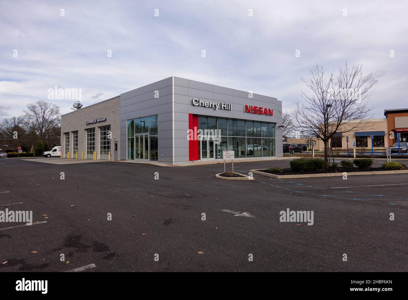 Cherry Hill, New Jersey - December, 2021: A Nissan car dealership with its parking lot almost empty due to a supply chain disruptions of materials use Stock Photo