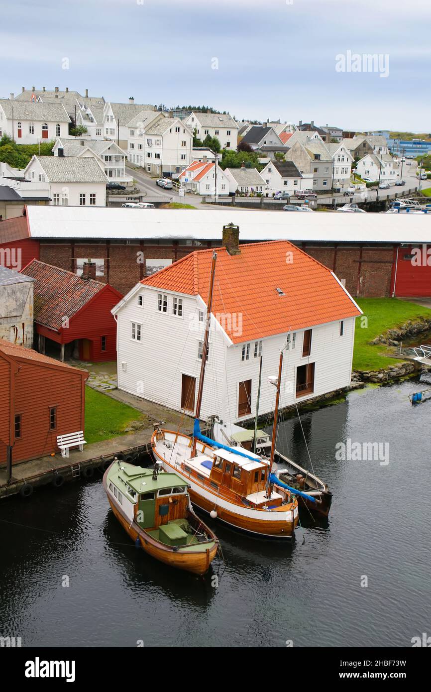 Traditional wooden buildings and boats along the waterfront and the marina. Smedasundet area and river in the center of the town, Haugesund, Norway. Stock Photo
