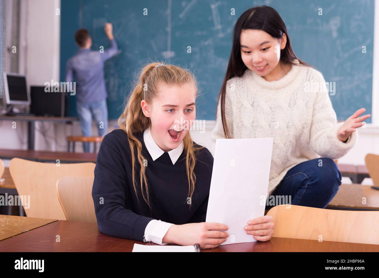 Delighted Schoolgirl And Chinese Girl Schoolmate Reading Notification Stock Photo Alamy Delighted Schoolgirl And Chinese Girl Schoolmate Reading Notification Stock Photo Alamy