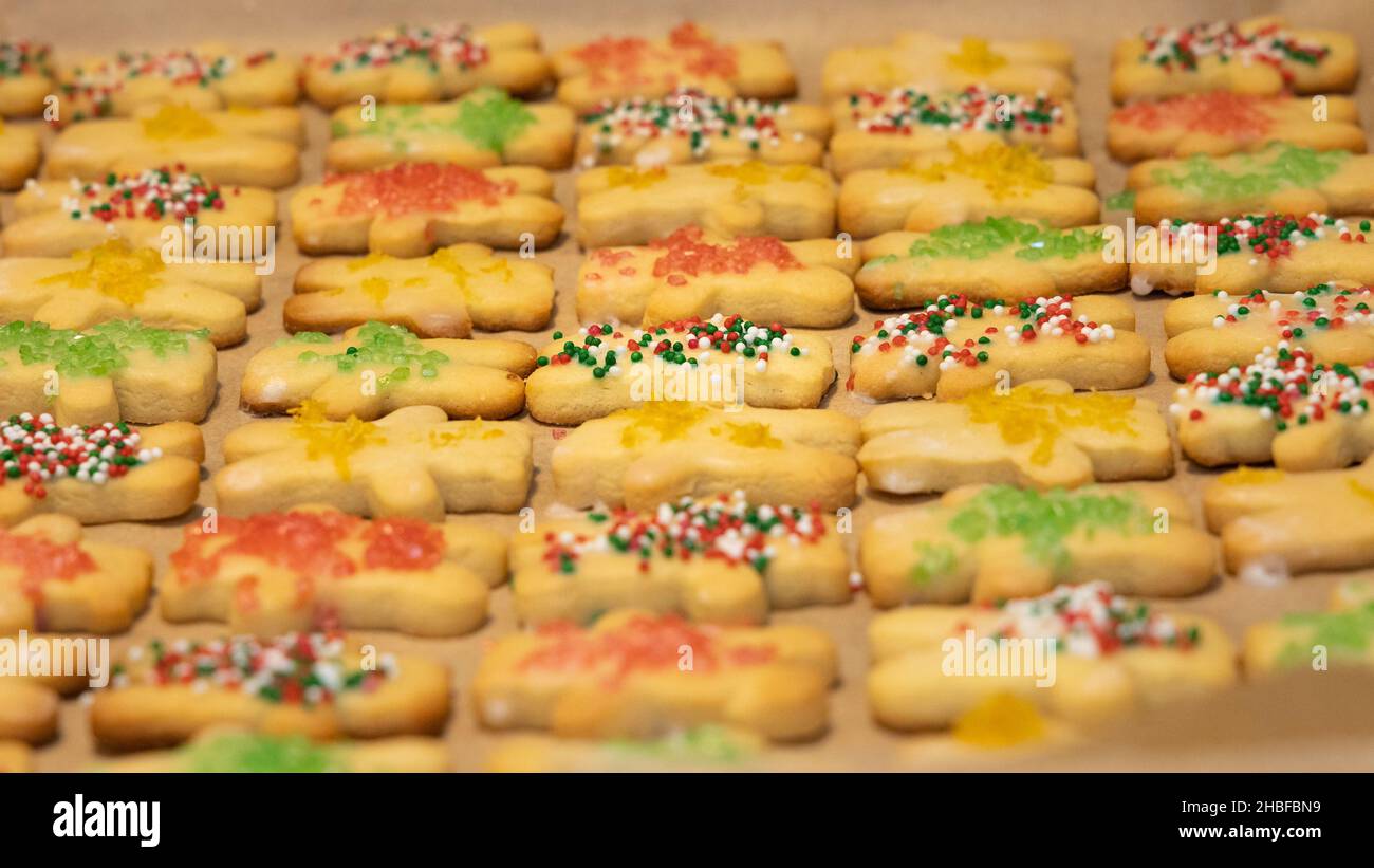 Cloesup view over a pan of christmas cookies, decorated with sugar coating and colorful sugar beads Stock Photo