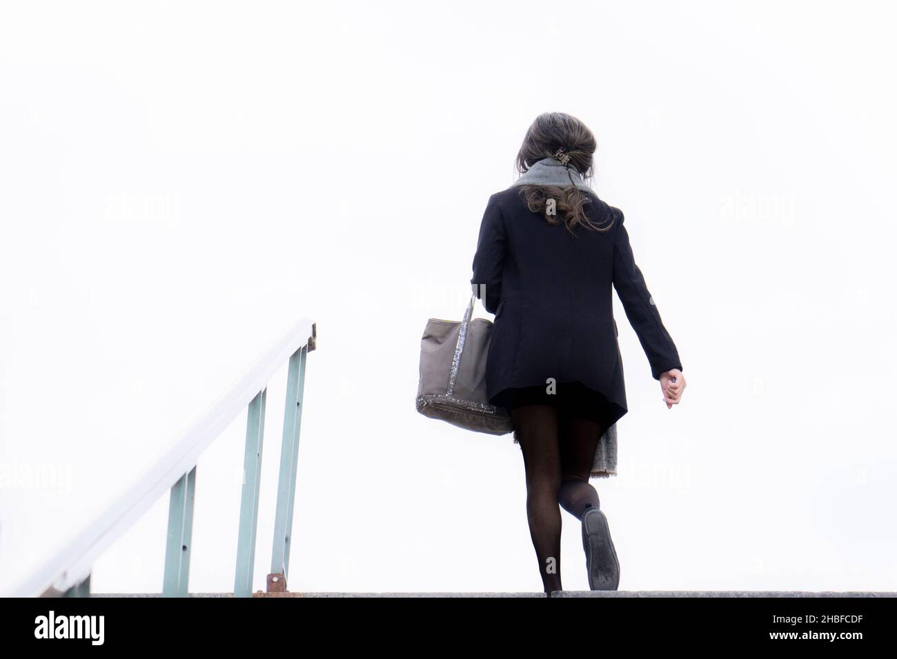 Businesswoman going up the stairs to work. Stock Photo