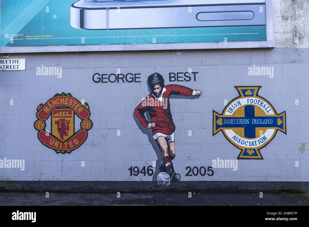 BELFAST, UNITED KINGDOM - Nov 02, 2021: A George Best mural with Manchester United and Northern Ireland soccer team logos in Belfast, UK Stock Photo