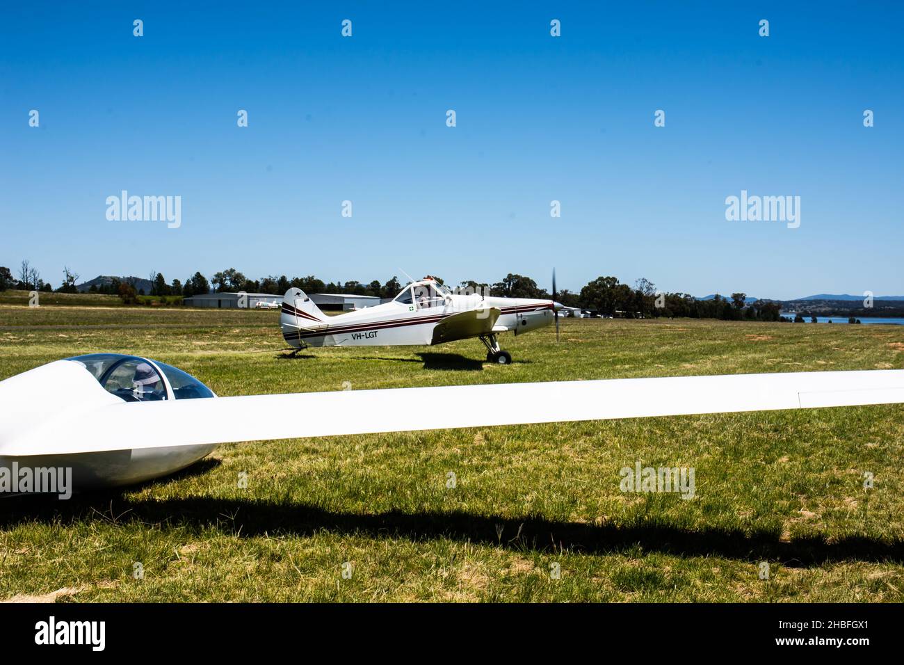 Tow plane taxiing onto grass runway to launch a Schleicher AS K21 sailplane at Lake Keepit Soaring Club,Gunnedah NSW Australia. Stock Photo