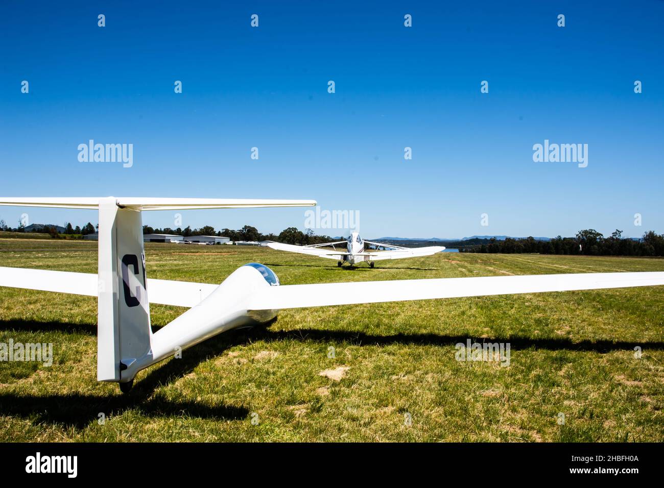 Plane taking up  slack of tow cable to launch a Schleicher, AS K21 sailplane at Lake Keepit Soaring Club,Gunnedah NSW Australia. Stock Photo