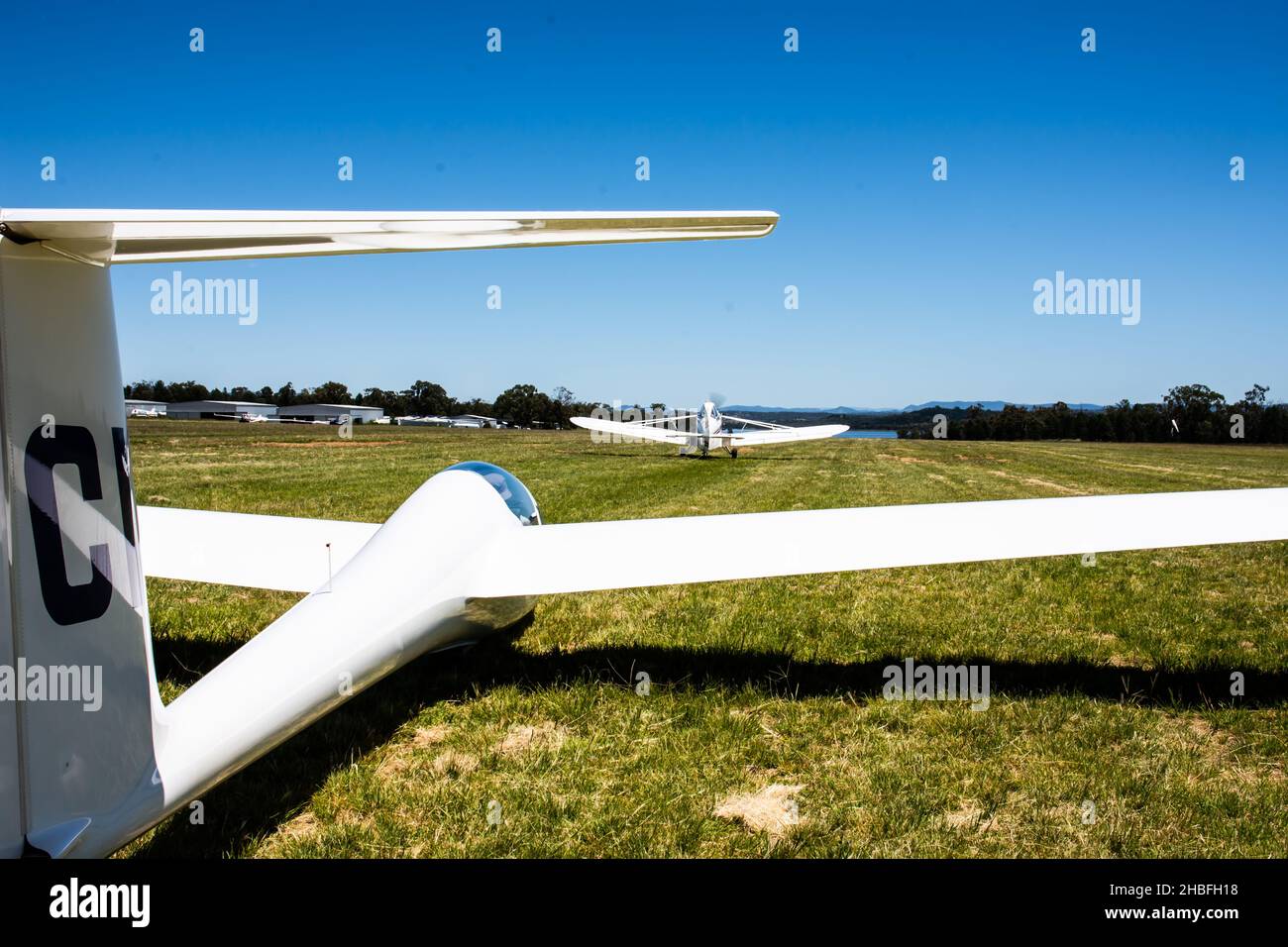 Plane taking up the slack of tow cable to launch a Schleicher, AS K21 sailplane at Lake Keepit Soaring Club,Gunnedah NSW Australia. Stock Photo