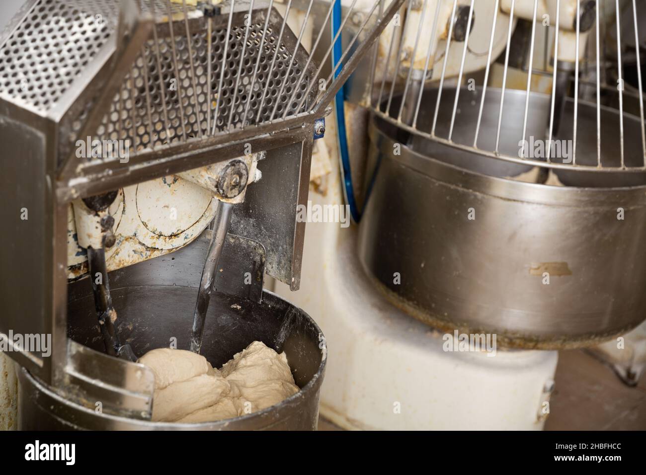 Making bread dough in kneading machine Stock Photo