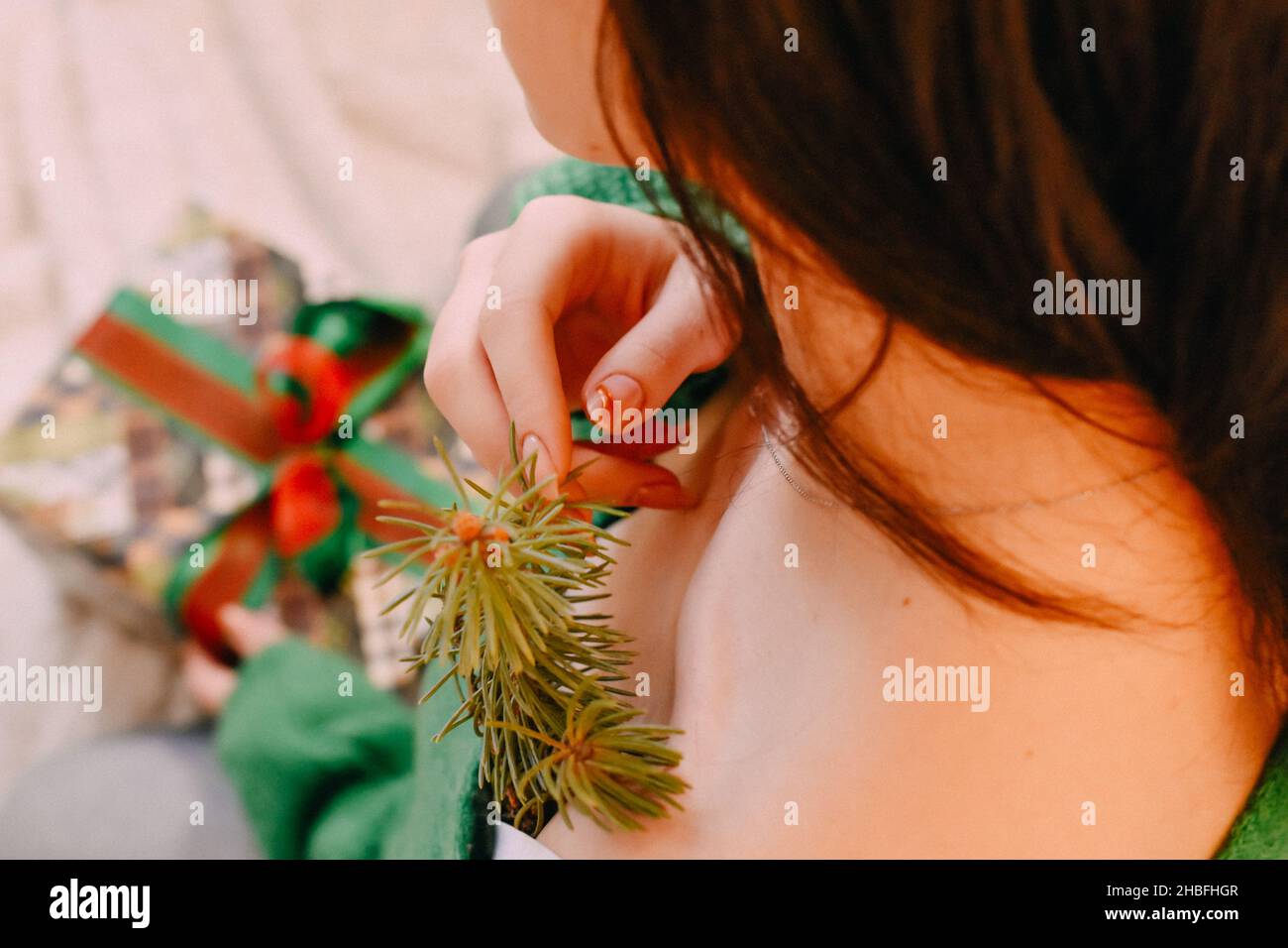 A closeup shot of a Caucasian girl with her Christmas gift Stock Photo