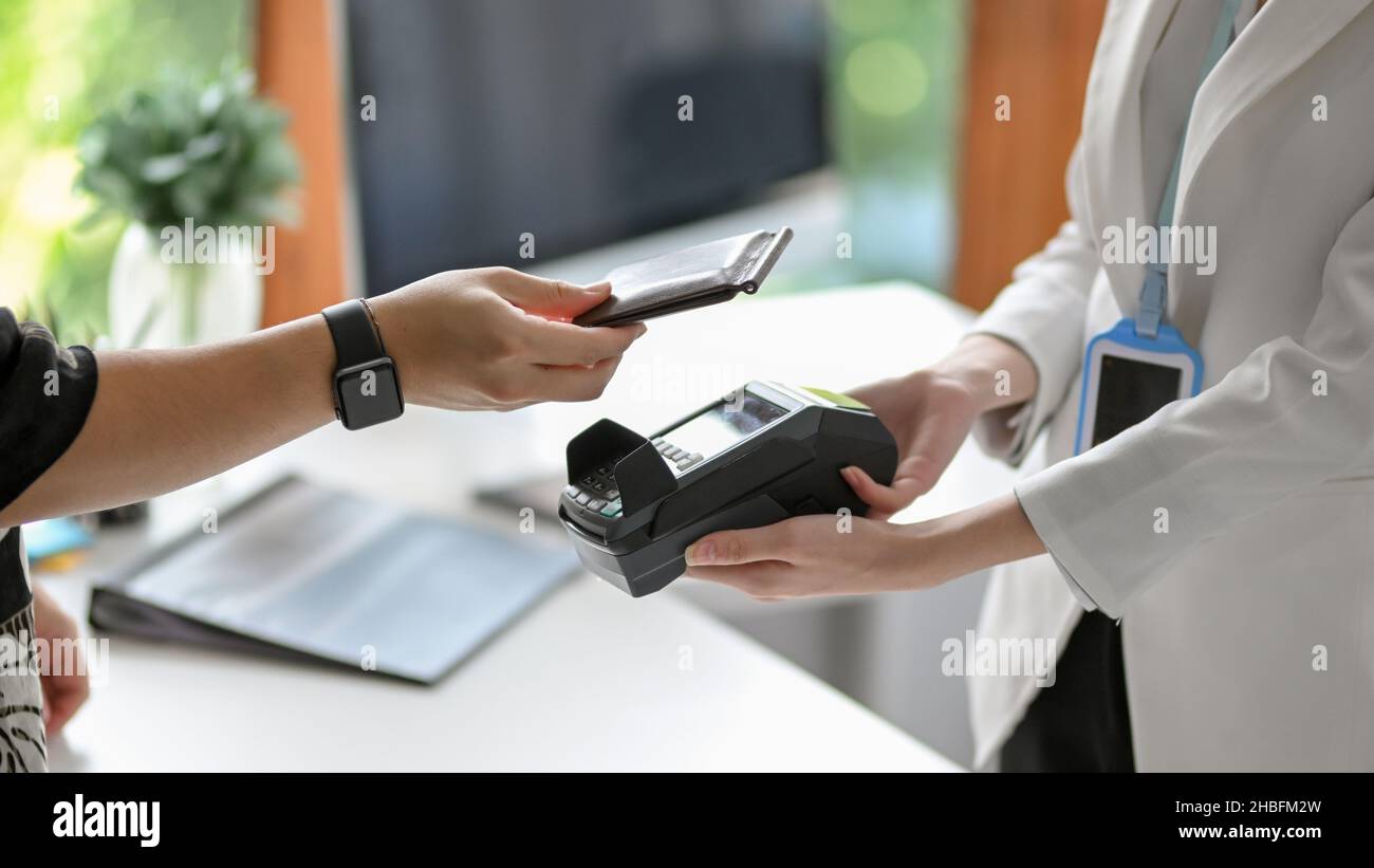 Closeup of a woman's hands using mobile payment to pay a bill through ...