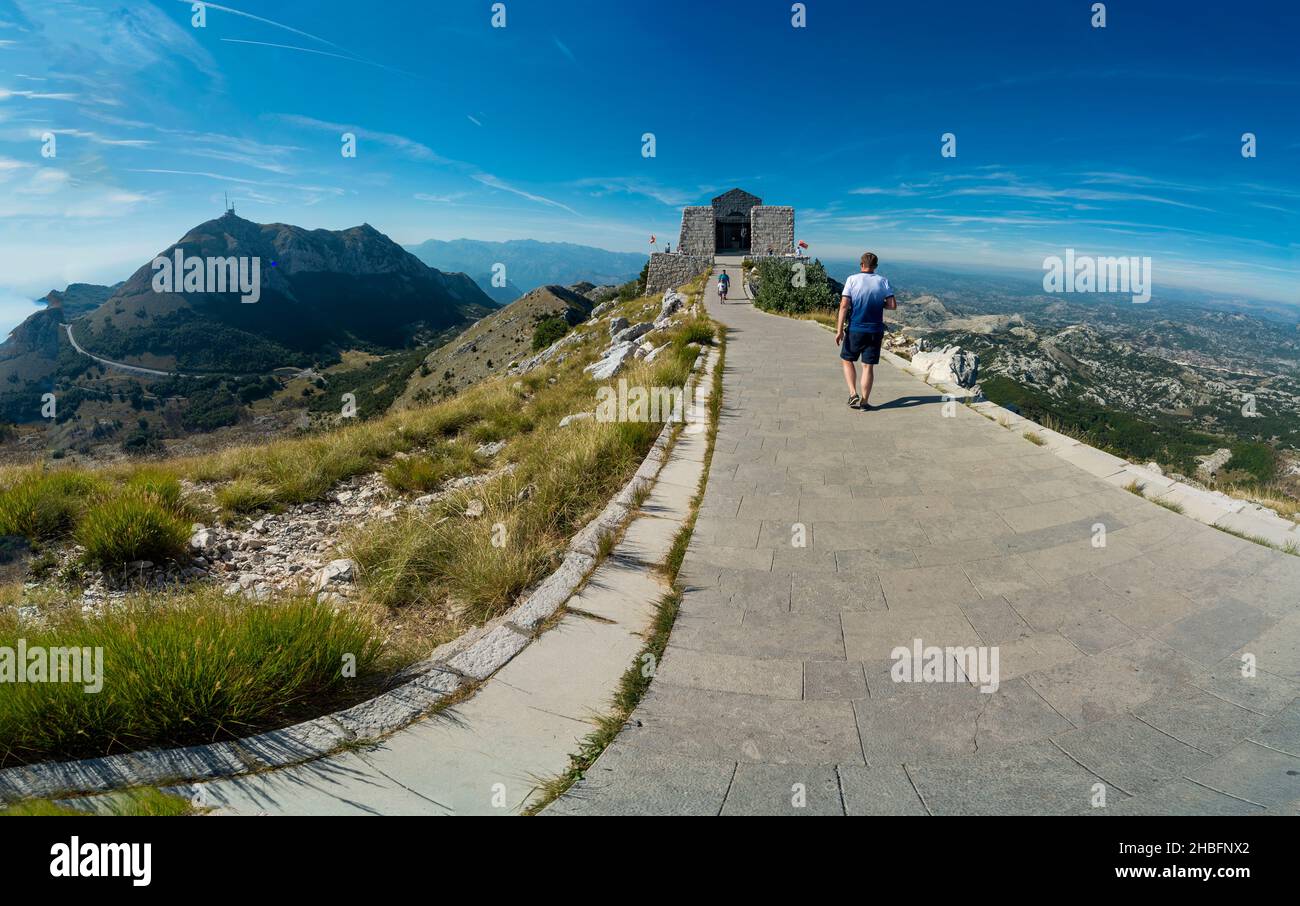 Lovcen National Park,Montenegro-September 14 2019:Under blue skies,tourists walk the pathway that leads to the famous tourist site and art installatio Stock Photo