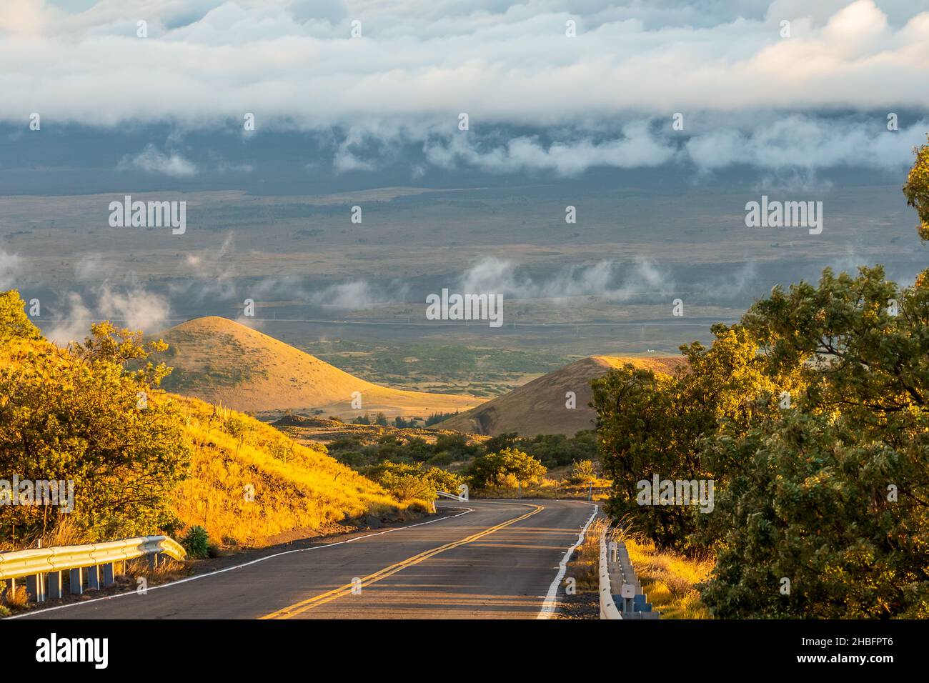 Scenic sunset view from the road leading to the observatories atop Mauna Kea and Onizuka Center for International Astronomy Visitor Station. Hawaii Stock Photo